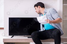 man-trying-fix-broken-tv-199861.jpg