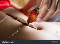 stock-photo-a-macro-shot-of-a-caucasian-woman-dipping-a-strawberry-in-the-melted-chocolate-spr...jpg