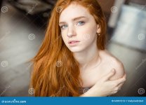 beautiful-redhead-woman-looking-camera-portrait-63051513.jpg