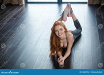 smiling-redhead-woman-lying-floor-portrait-looking-camera-63049996.jpg