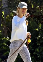 Gisele-Bundchen-sports-a-white-sweatshirt-and-animal-print-leggings-while-enjoying-a-stroll-wi...jpg