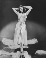 Rita Hayworth in a pale pink satin dress photographed by George Hoyningen Huene for Harper's B...jpg