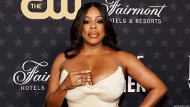 actress-niecy-nash-in-front-of-a-step-and-repeat-screen-sponsored-by-the-cw-and-fairmont-hotels.jpg